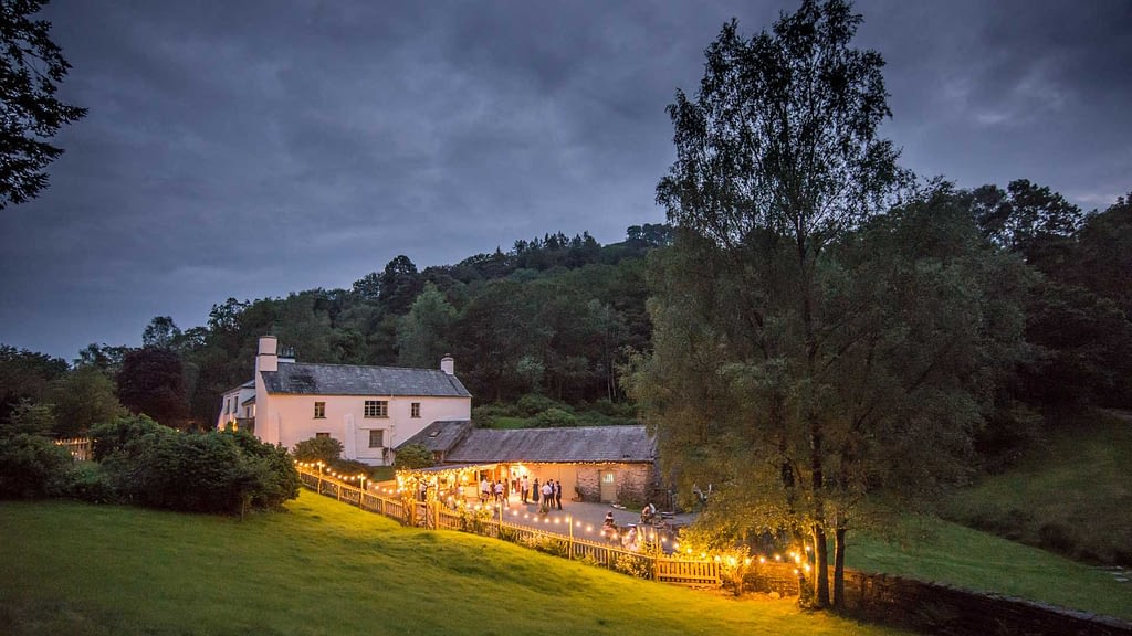 The Country House and Wedding Barn at Cote How illuminated at dusk twilight