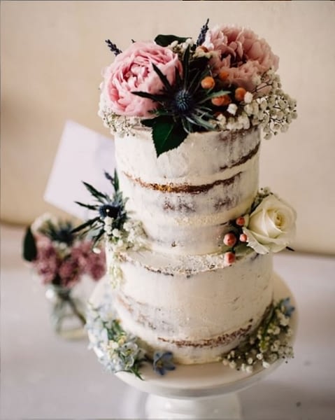 Semi-naked wedding sponge cake with fresh flower decoration
