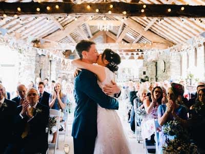 An indoor barn wedding cermeony by Rachel Joyce