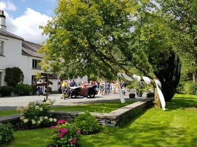 Drinks reception in full flow with guests arriving on the terrace at Cote How Lake District Weddings
