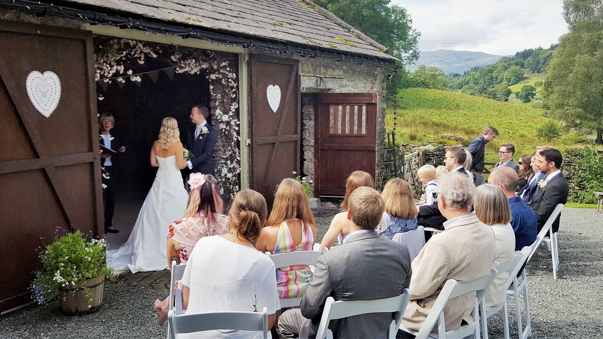 Small wedding ceremony outside the rustic barn