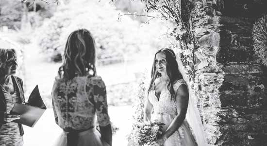 Lovely Couple tying he knot in the decorated barn archway