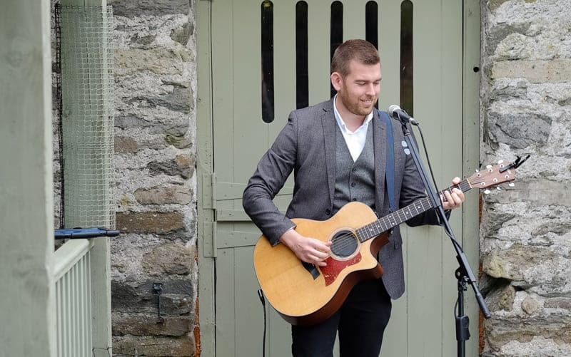 Alex Birtwell Wedding Entertainer singer outside the wedding barn