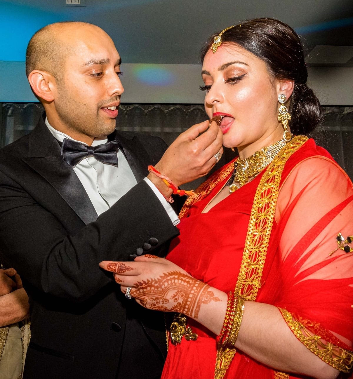 Asian Wedidng - Bride and Groom eating wedding cake