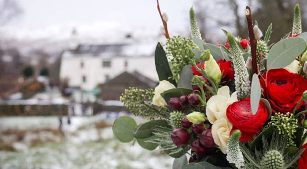 Stunning flower bouquet and small winter wedding venue