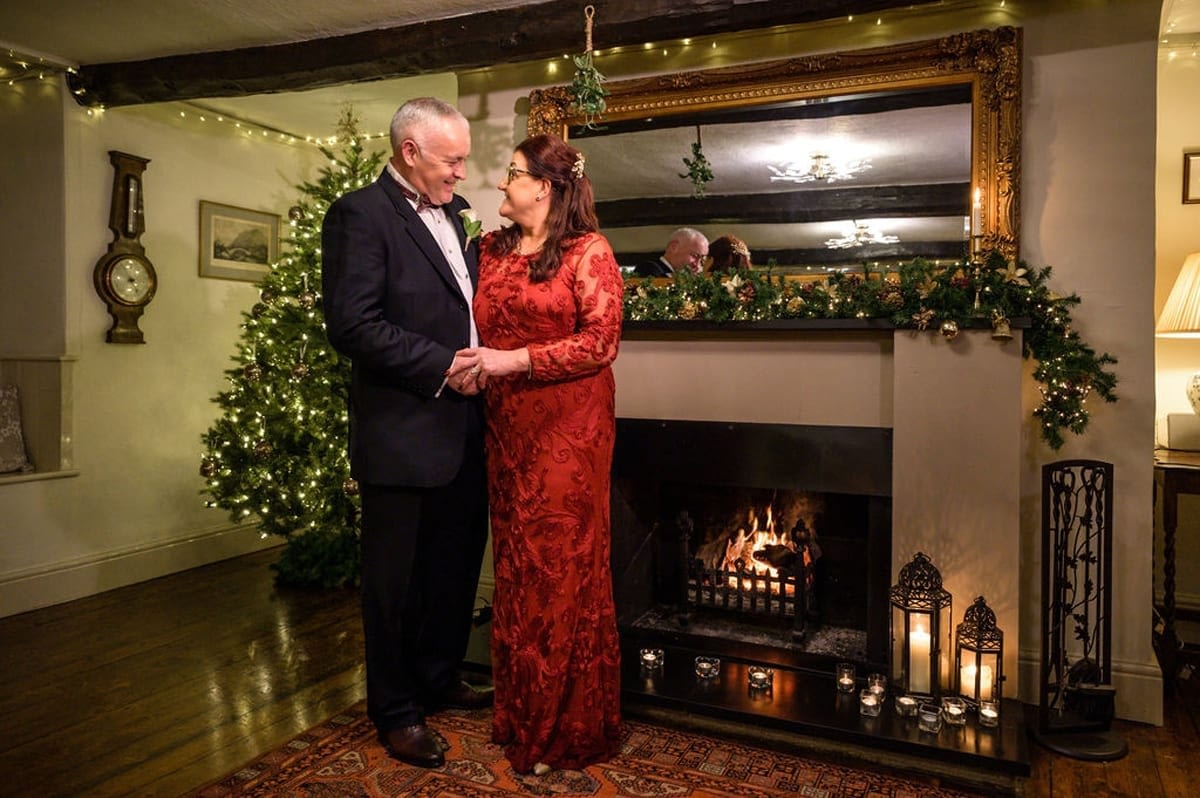 Bride-and-Groom-with-Chritmas-Tree-and-Hearth---Just-Married-after-their-Elopement-wedding-in-the-Lake-District