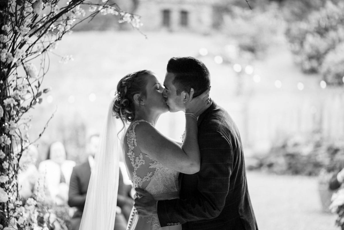 Wedding Couple - First Kiss in the Barn Doorway at Cote How in the Lake District