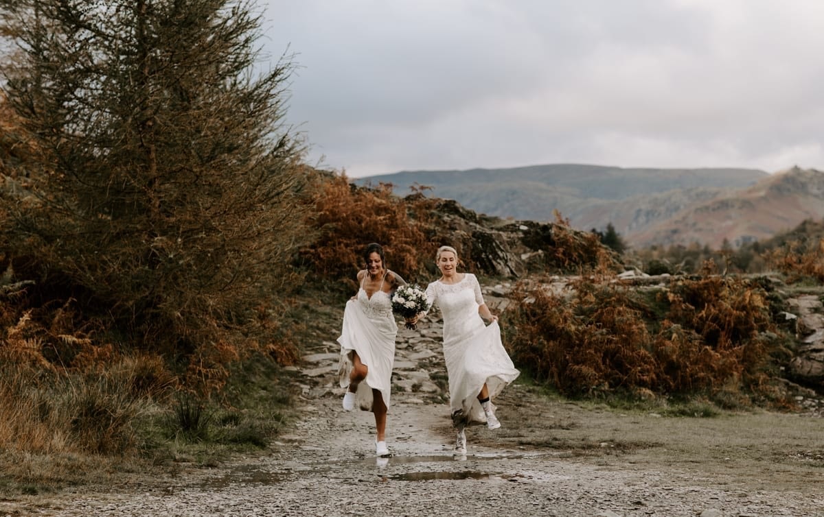 Two Brides Hiking in the mountains after their adventure wedding