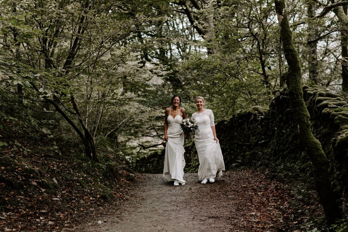 Brides hiking on their wedding day in the Lakes