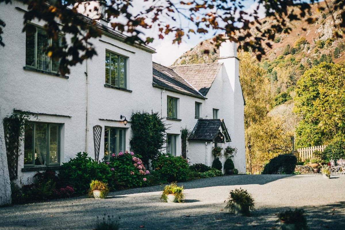 White Historic Farmhouse wedding Venue with Nab Scar mountain behind it