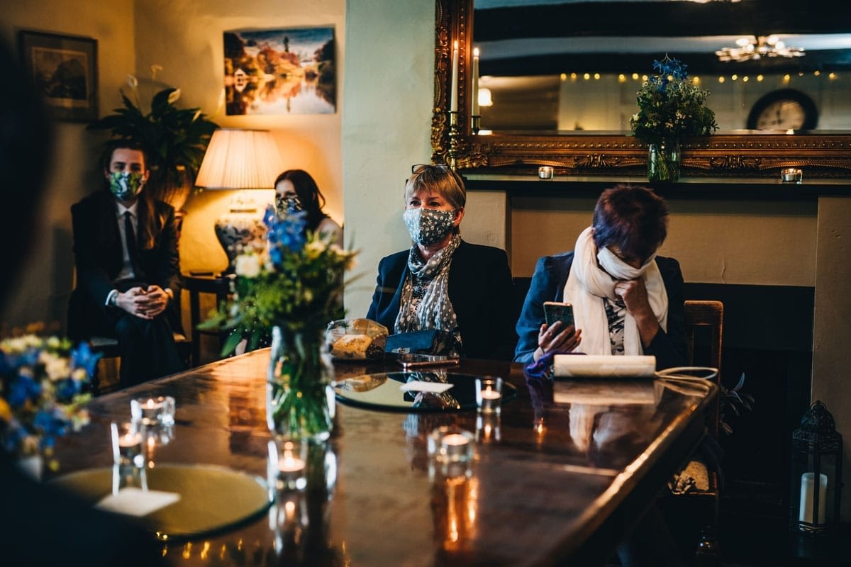 Guests waiting for the wedding ceremony sitting in household bubbles in a Covid-Secure Wedidng Venue in the Lakes