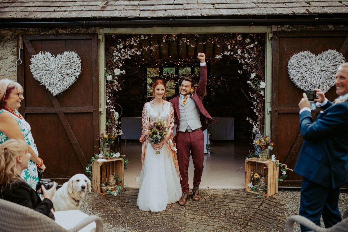 Bride and Groom in the arches of the barn for an al fresco wedding