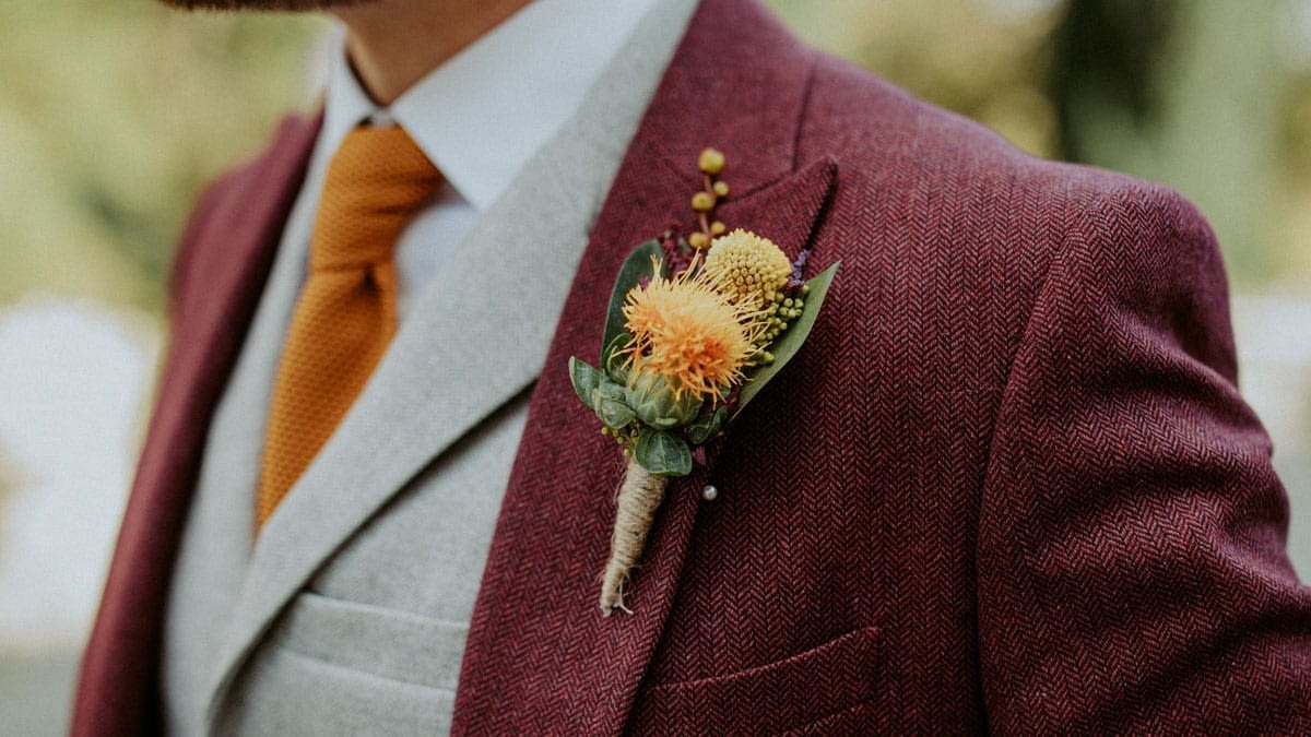 Grooms Burgundy suit and buttonhole