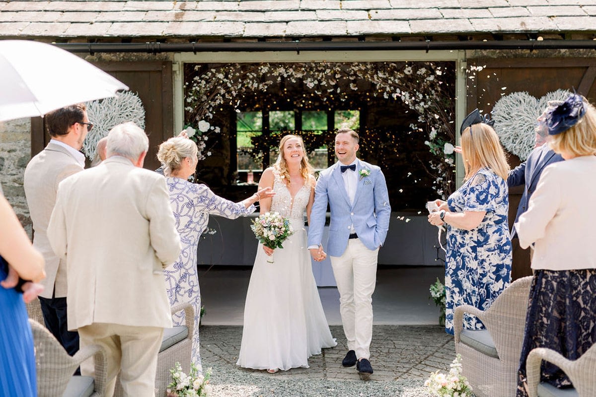 Confetti thrown over Bride and Groom just married at small wedding venue
