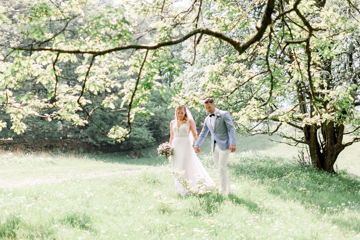 Wedding couple holding hands at lakeland venue
