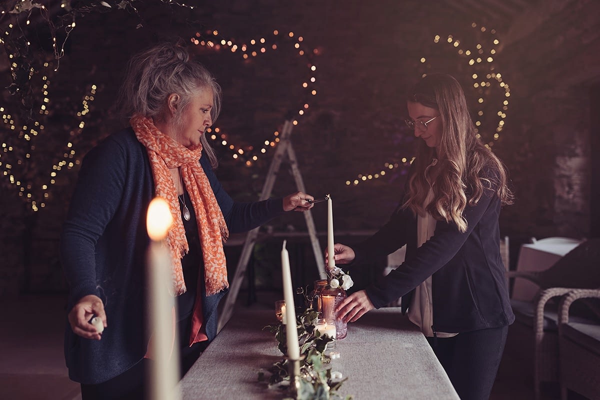 Caroline and Sophie setting up the dinner table in the barn at Cote How