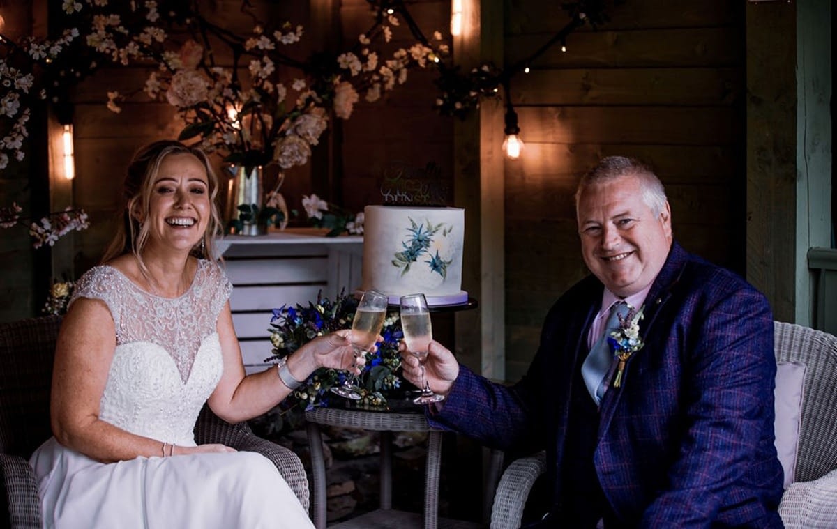 Elopement couple drinking prosecco in Cote How gazebo