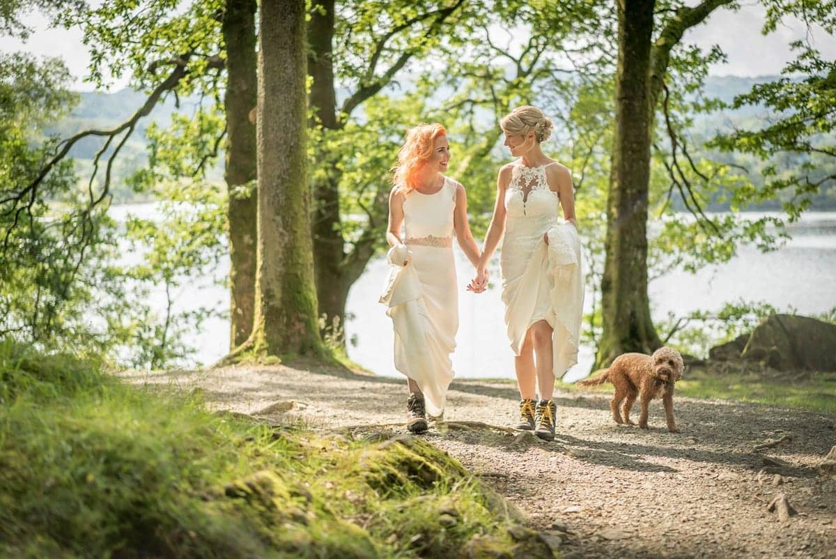 Two-Brides-strolling-through-Rydal-Woods-with-the-dog
