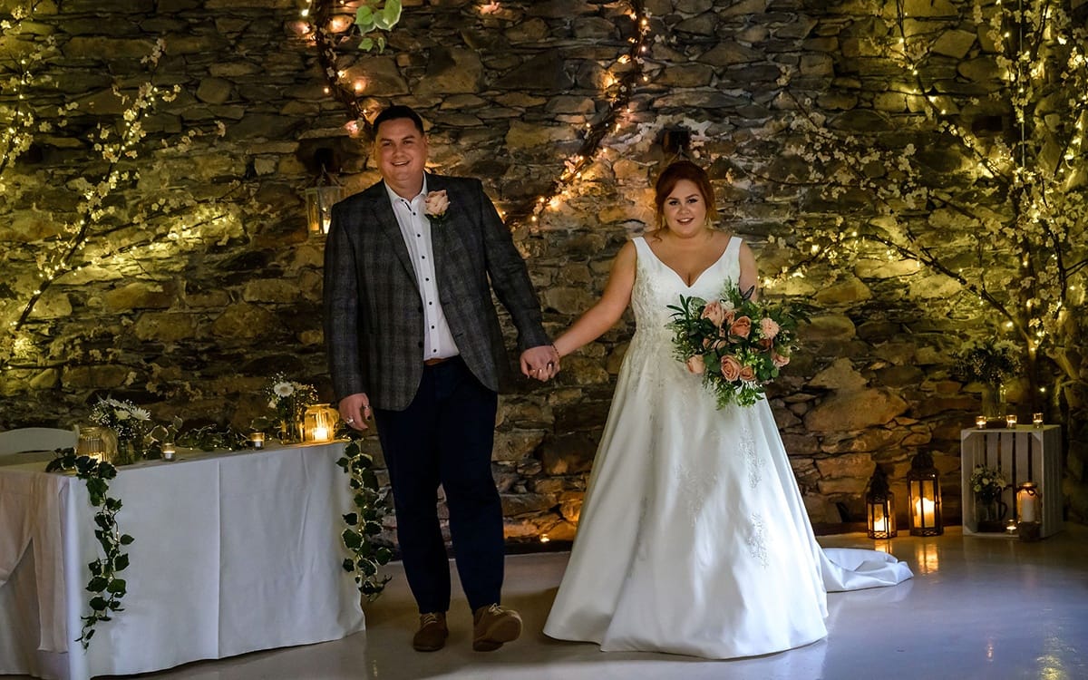 Just married couple walking down the aisle in the barn