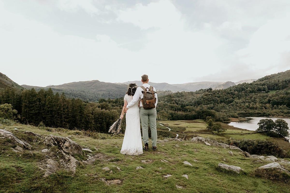 Wedding Couple stood in the perfect wedding location with view over Rydal