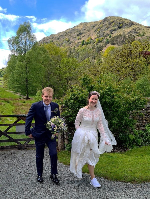 Wedding couple walking back from Rydal Water to best wedding venue Cote How