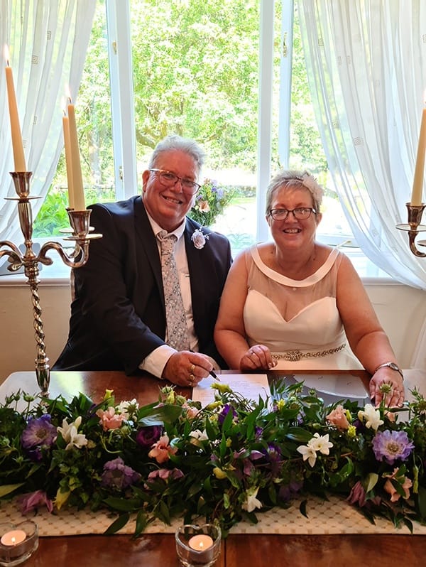 Best wedding venue Happy Couple signing during ceremony at Cote How