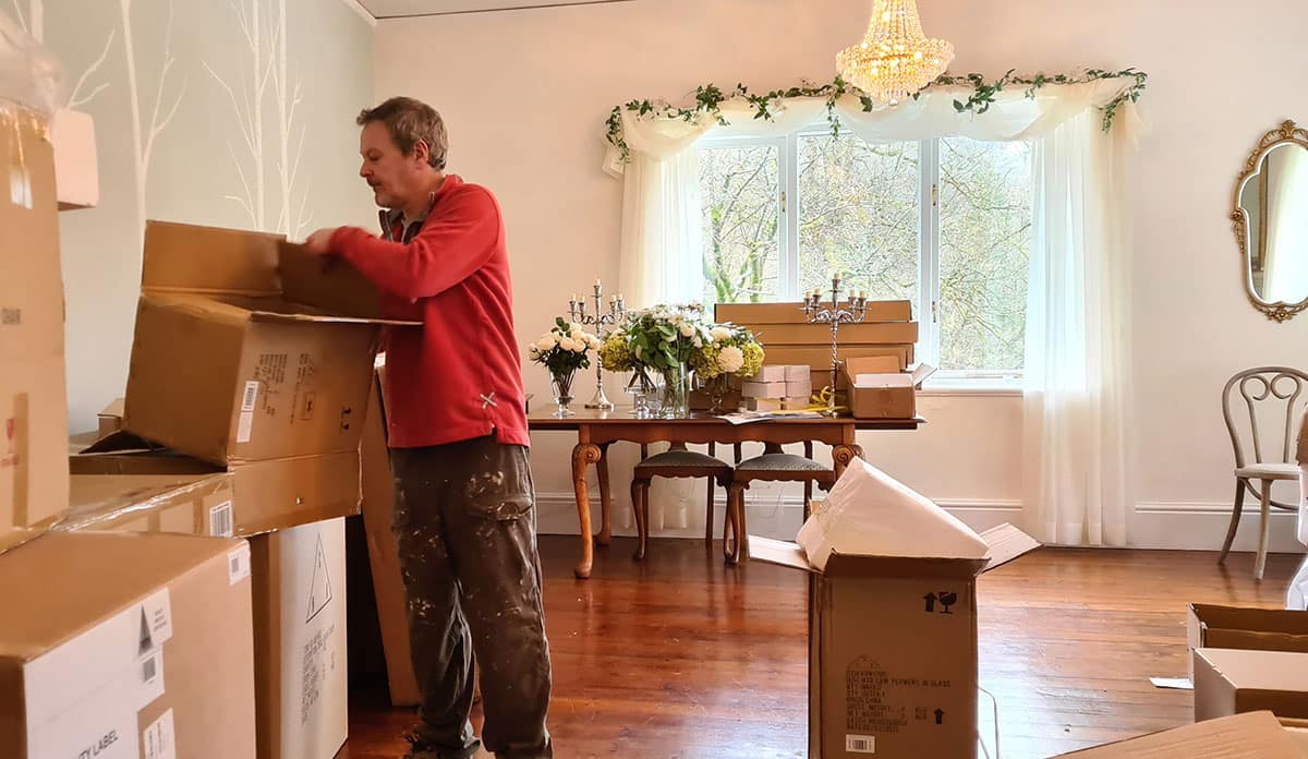Steve unpacking the new wedding venue furniture